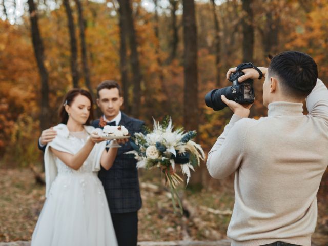 wedding photographer taking pictures of the bride and groom
